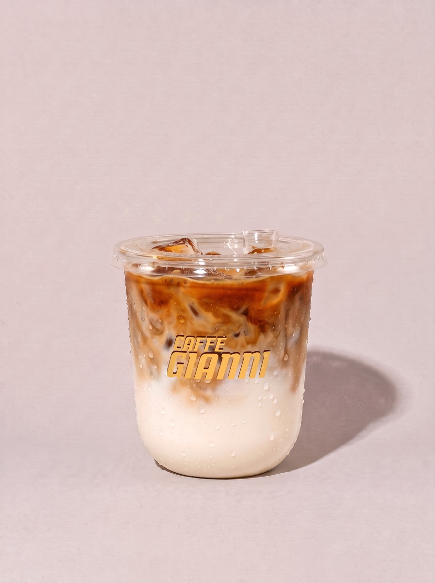 ICED LATTE, espresso over milk and ice, with a sip lid, in a Caffè Gianni cup