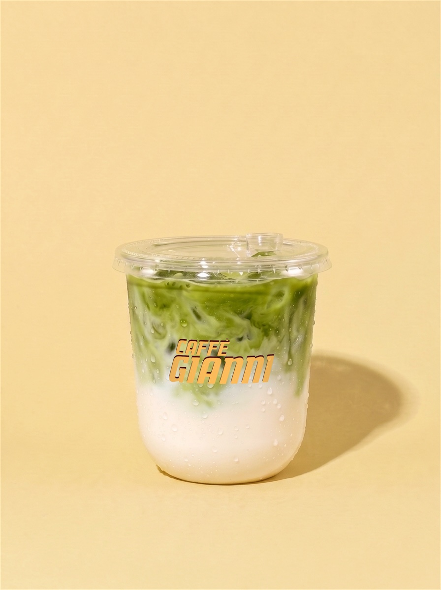 ICED MATCHA LATTE, matcha over milk and ice, with a sip lid, in a Caffè Gianni cup